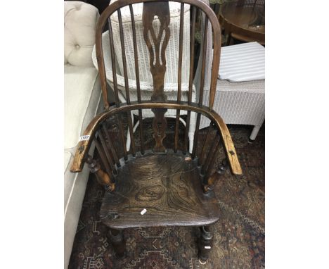 An elm stick back chair with open arms soild seat on turned legs