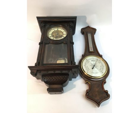 A carved wood wall clock and Mappin and Webb barometer