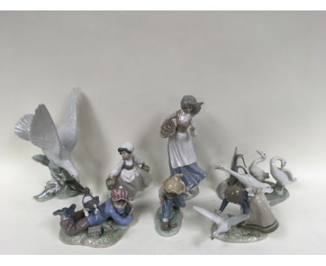 A collection of seven Lladro and NAO figures, some damage