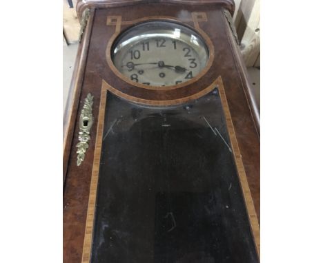 A French walnut wall clock with applied gilt metal mounts the silvered dial with Arabic numarls and visible pendulum
