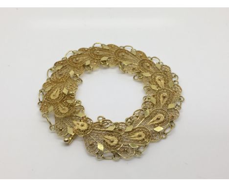 An 18ct yellow gold fancy filigree bracelet, approx 14g.