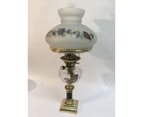 A brass oil lamp with a floral decorated frosted glass shade, approx 61cm.