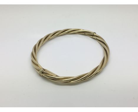 A 9ct yellow gold twisted design bangle, approx 17.2g.