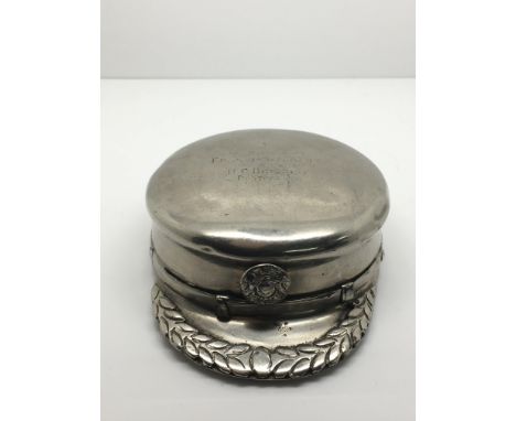 A novelty silver plated snuff box shaped as a military cap, engraved to top.Approximately 8.5cm long