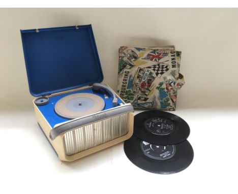 A 1960's Tri-ang portable record player and a vintage record case containing various 7 inch singles.