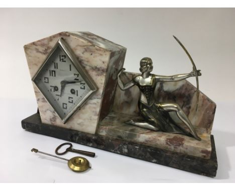 An Art Deco eight day marble mantle clock decorated with a maiden in typical Art Deco pose with garnitures.