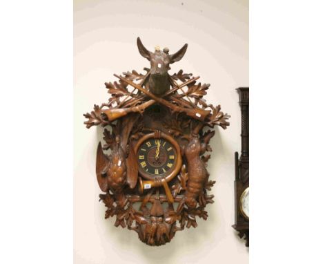 Impressive Very Large Black Forest Cuckoo Wall Clock, ornately carved with a Deer Head Finial with Two Crossed Shot Guns, the