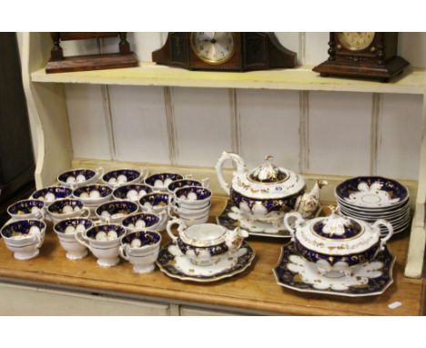 19th century Tea Set, each piece with a white body decorated with deep blue and gold highlights comprising Tea Pot, Sucrier, 