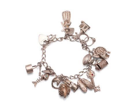 Silver charm bracelet with a key, an oil lamp, a church and others, 55.1g.