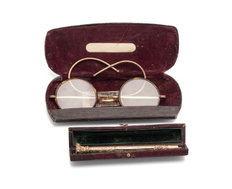 A late Victorian or Edwardian, propelling pencil the engraved body with florette pushers, the foliate finial with citrine sea