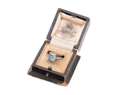 An Art Deco, 18ct white gold, platinum and aquamarine dress ring, the emerald cut aquamarine of approximately 9.1 by 8.5mm, i