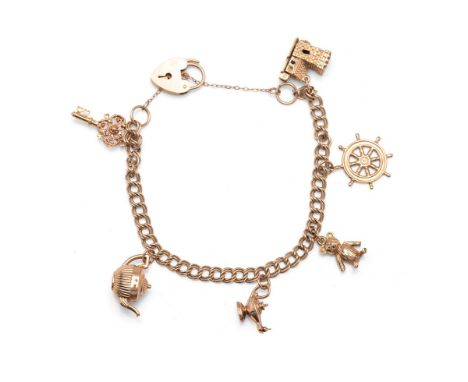 A 9ct gold charm bracelet of fine double curb link form with heart shaped padlock clasp and hung with six hallmarked 9ct gold