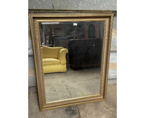 Wall mirror, bevelled rectangular plate in receded cushion frame, total size 118 x 97cm