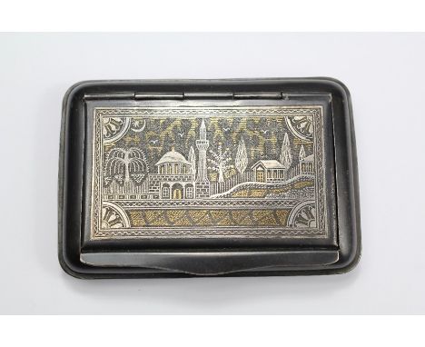 A Koftgari Snuff Box. The snuff box inlaid with silver and gold, approx 10 x 6 x 1.5 cms.