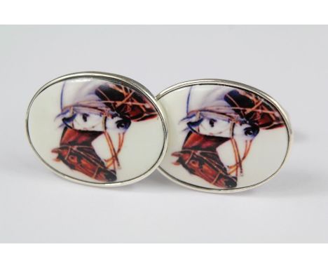 A Pair of Oval Silver and Enamel Cuff Links. The cuff links in the form of horses.&nbsp;