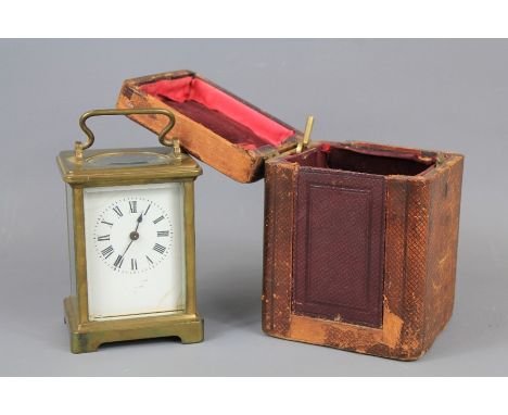 A 19th Century Carriage Clock. The clock having a white enamel face with Roman dial, French brass movement, housed in a red m