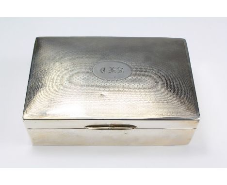 A Silver Engine-Turned Cigarette Box. The box London hallmark, dated 1933, approx 9.5 x 14.5 cms, monogrammed C.F.R.