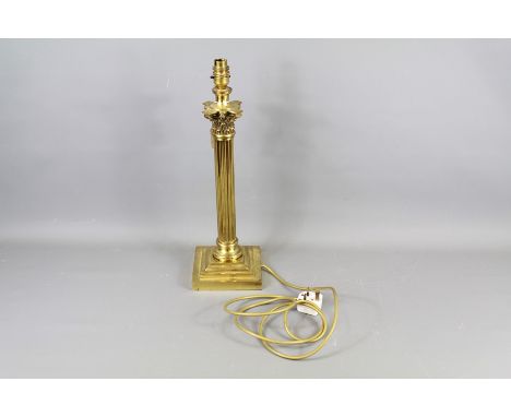 A Brass Standard Lamp. This standard lamp with telescopic adjuster approx 170 cms together with a brass Corinthian column lam
