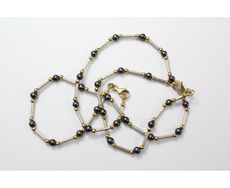 An 18ct Yellow and White Gold Pearl Necklace and Bracelet. The necklace and bracket having polished beads and burnished rods,