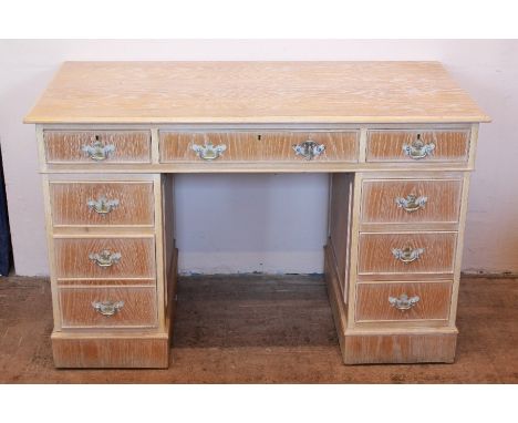 A Light Oak-Finish Office Desk. The desk with four short drawers and a single central drawer, approx 122 x 62 x 78 cms.