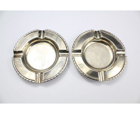 A Pair of Silver Ashtrays. The ashtrays London hallmark, dated 1931, approx 12 cms diameter. approx 207 gms, mm Henry Wilkins