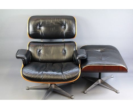Vintage Rosewood and Black Eames Lounge Chair.  The chair with leather back, seat and arm rests upon a rosewood veneered fram