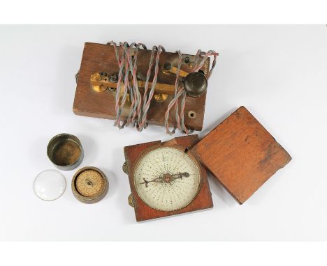 A Pair of Vintage Compasses. The first a brass and paper compass in a mahogany box and the other a pocket sundial navigation 