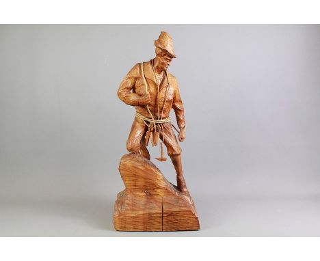 A Vintage Wood Carving of an Alpine Mountaineer. The figure carved from a solid block of wood and the climber is complete wit