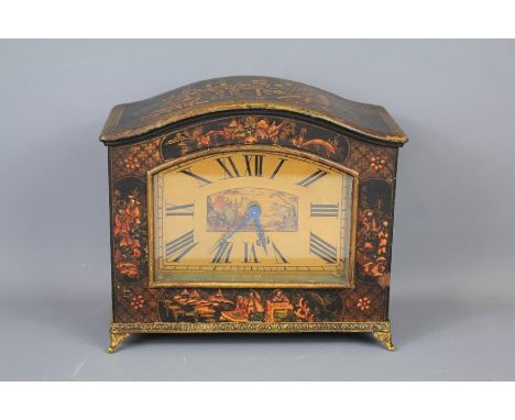 An Early 20th Century Chinoiserie Mantel Clock. The clock depicting figures in a domestic setting, circa 1900, with a burnish