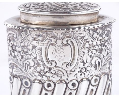 A George V navette-shaped silver tea caddy, half fluted form with relief embossed floral decoration, by William Hutton & Sons