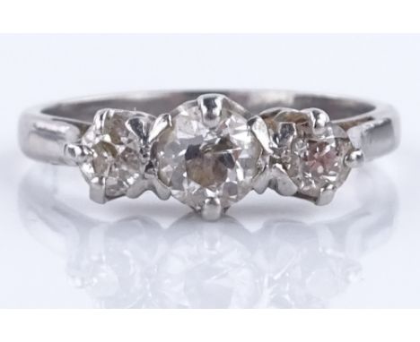 A 3 stone diamond ring, unmarked white metal settings, total diamond content approx. 0.98cts, central stone approx. 0.51cts, 