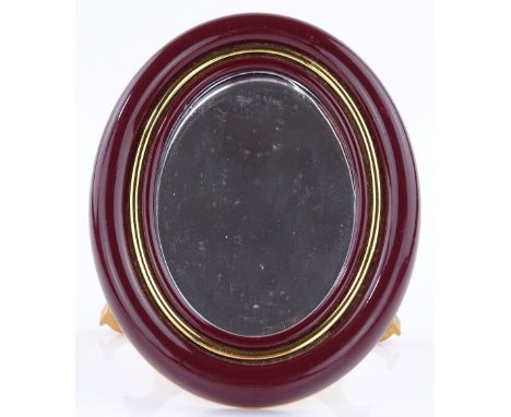 A Cartier red enamel-framed travelling toilet mirror, height 9cm