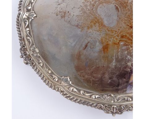 A large circular silver tea tray, with engraved floral decoration and scalloped edge, by William Hutton & Sons, hallmarks Lon