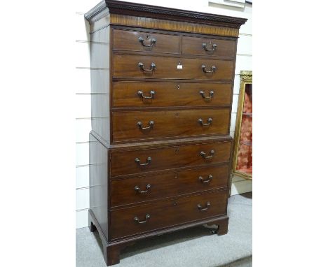A George III mahogany chest on chest, carved and inlaid pediment with brass drop handles and bracket feet, width 3'6", height