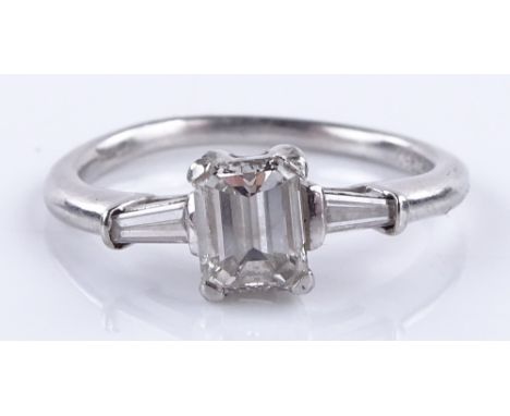 A platinum 3-stone diamond ring, central emerald-cut diamond approx 0.5cts, with tapered baguette-cut diamond shoulders, size