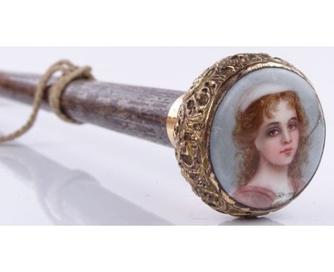 A 19th century walking cane with inset miniature painted portrait of a girl on porcelain (A/F), in ornate gold plated mount 