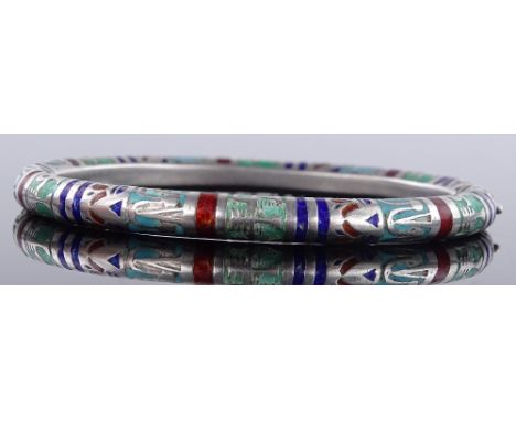 An unmarked silver and coloured enamel hinged bangle, with Egyptian symbol decoration