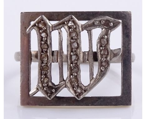 An unusual chip diamond set W monogram ring, unmarked white metal settings, panel height 15.6mm, size R, 5g