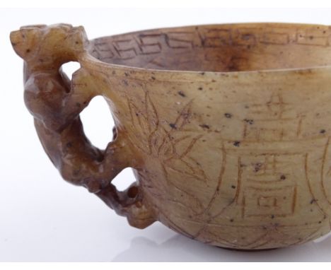 A Chinese carved hardstone / jade cup with mythical beast handles, width 9cm