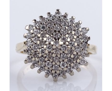 An 18ct gold diamond cluster ring, total diamond content approx 0.75cts, setting height 15.1mm, size J, 4.4g