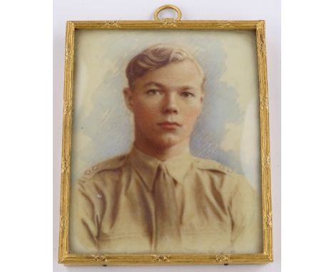 A German Second War period miniature portrait of a boy, watercolour over a printed base, gilt metal frame, height 9cm