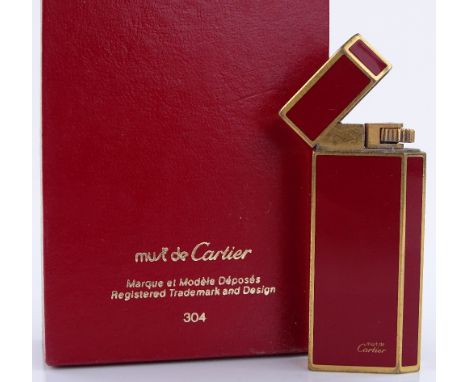 A Cartier red enamel and gold plate pocket lighter, height 6cm, boxed with papers