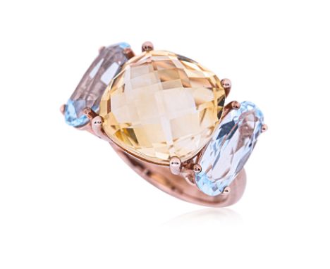 A LEMON QUARTZ AND TOPAZ RING Featuring a checkered cut lemon quartz weighing approximately 5.0 Cts, mounted in a 9K rose gol