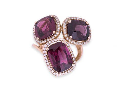 A GARNET AND DIAMOND RING Featuring three purplish garnets weighing approximately 13.0 Cts, mounted in an 18K rose gold setti