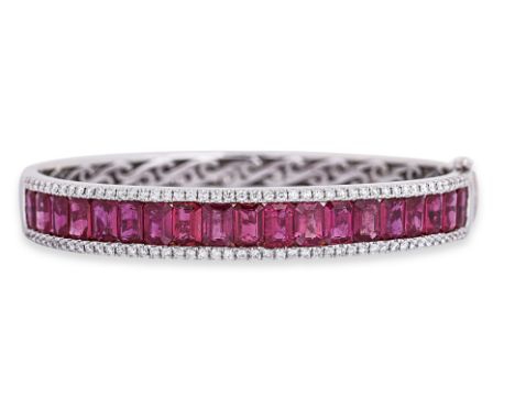 A RUBY AND DIAMOND BANGLE Featuring 19 emerald cut rubies weighing totalling approximately 11.57 Cts (marked), mounted in an 