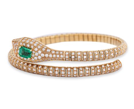 AN EMERALD AND DIAMOND 'SERPENT' BANGLE Featuring an emerald cut emerald weighing approximately 0.95 Cts, mounted in an 18K y