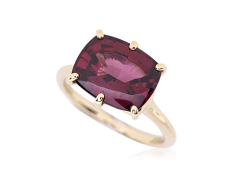 A GARNET RING Featuring a mixed cut garnet, weighing approximately 6.52 Cts (marked), mounted in a 18K yellow gold setting ma