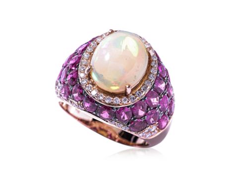 AN OPAL, RUBY AND DIAMOND RING Featuring an Ethiopian opal weighing approximately 2.25 Cts (marked), accented with oval cut r