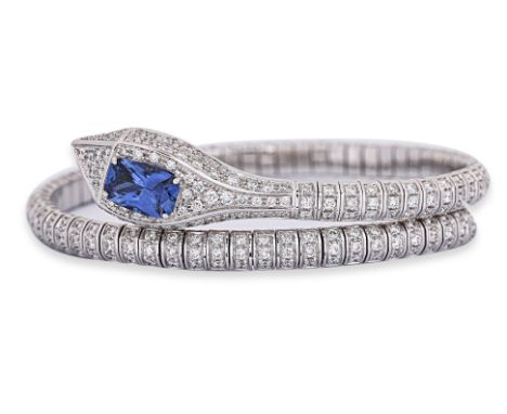 A SAPPHIRE AND DIAMOND 'SERPENT' BANGLE Featuring a cushion cut sapphire weighing approximately 2.00 Cts, mounted in an 18K w