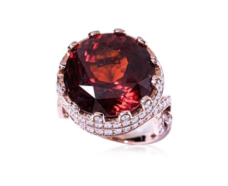 A LARGE HESSONITE GARNET AND DIAMOND RING Featuring a Hessonite garnet weighing approximately 21.22 Cts, mounted in an 18K ro